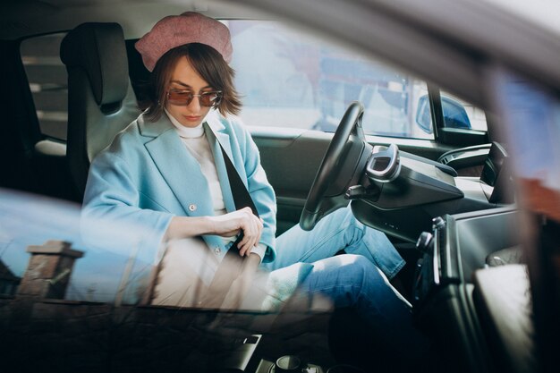 Young woman travelling by electric car