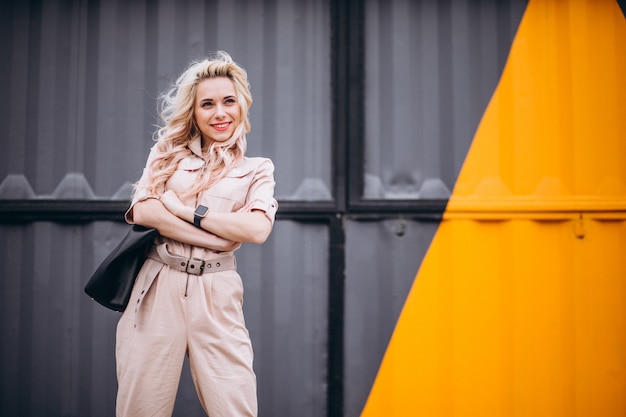 Free photo young woman in trendy pink overall