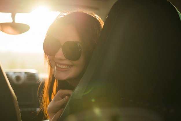 Free photo young woman on a trip in a car