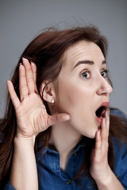 Young woman trying to listen something