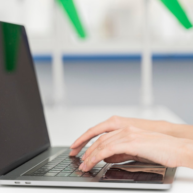 Young woman typing on a laptop keyboard