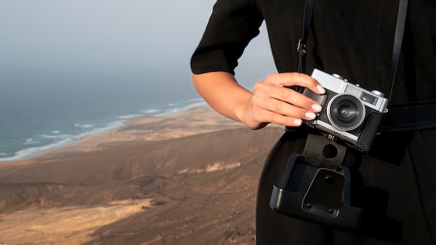 Young woman using a camera in her vacation