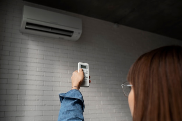 Free photo young woman using home technology