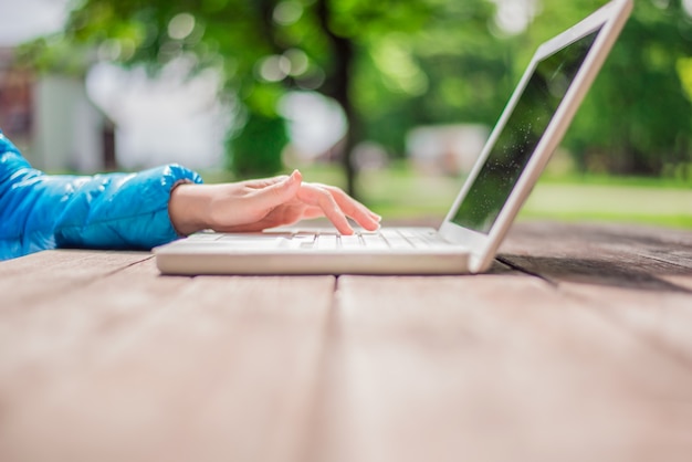 Free Photo young woman using laptop outside room,happy moment on holiday, l