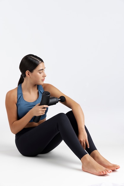 Young woman using message gun