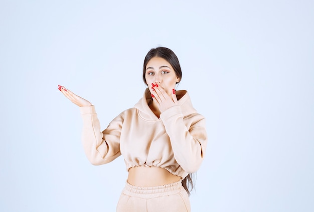 Young woman using open hands to present and talk about something