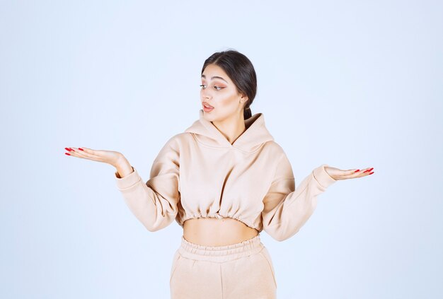 Young woman using open hands to present and talk about something