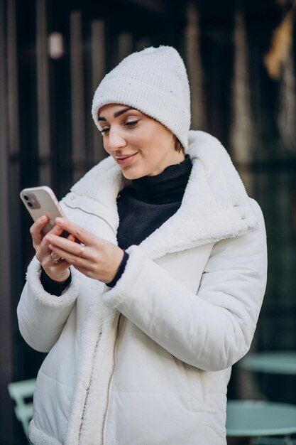 Young woman using phone outdoors