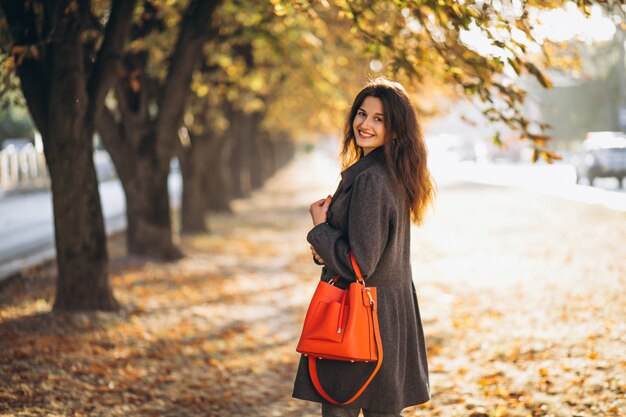 Young woman walking in an autumn park