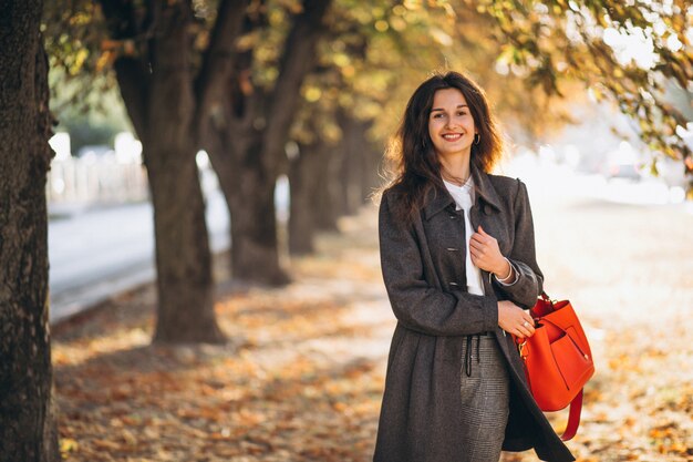 Young woman walking in an autumn park