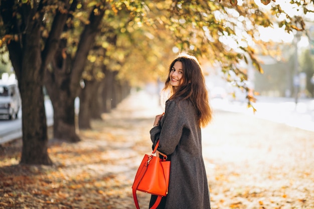 Young woman walking in an autumn park