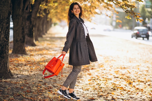 Young woman walking in an autumn park