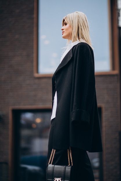 Young woman walking by the building