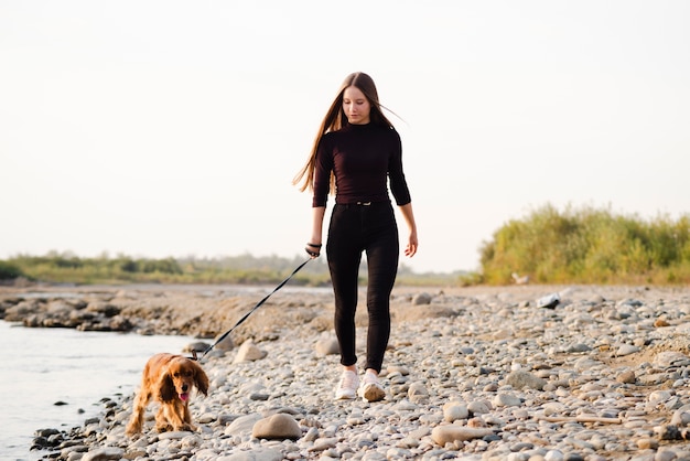 Young woman walking her dog outdoor