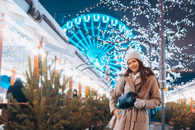 Free Photo young woman walking on market with trees