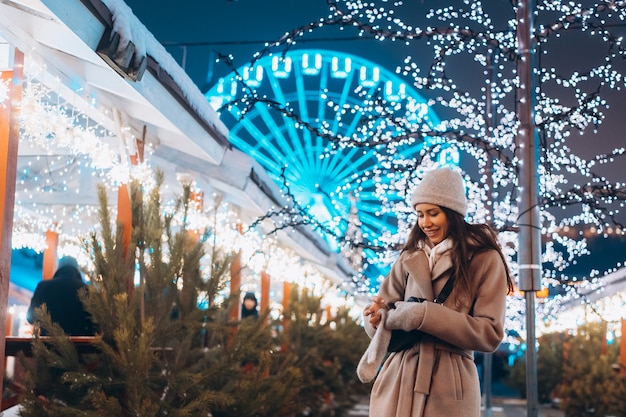 Young woman walking on market with trees