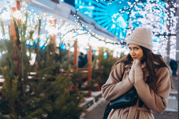 Young woman walking on market with trees