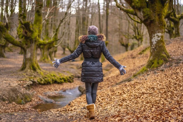 Young woman walking in Otzarreta Forest in the natural park of Gorbea, Bizkaia, Basque Country