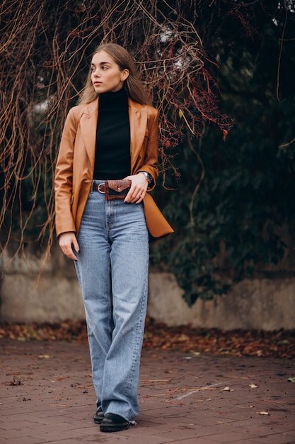 Free photo young woman walking in park