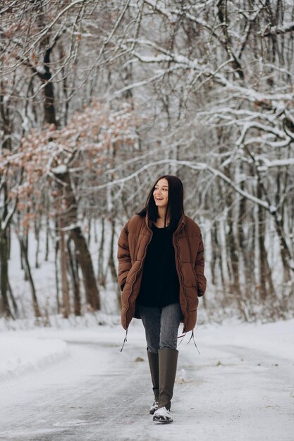 Young woman walking in winter park