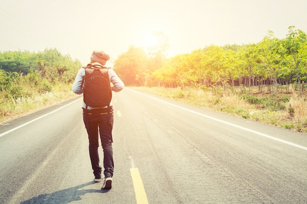 Free photo young woman walking with her backpack