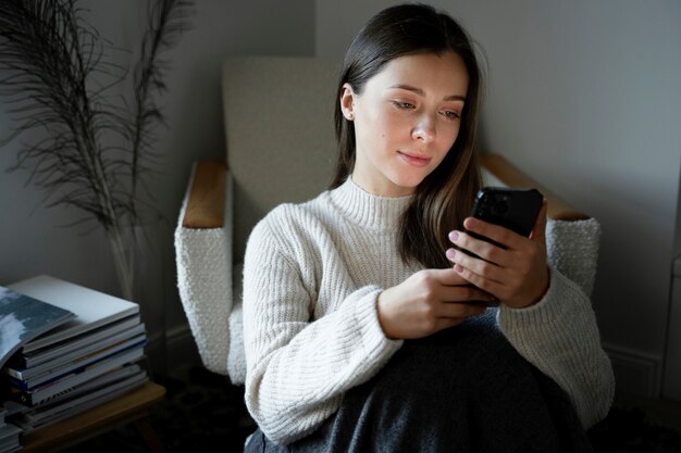 Young woman watching a video using her smartphone