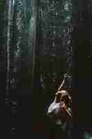 Free photo young woman at the waterfall in the rock bali indonesia