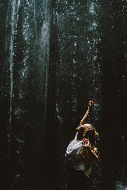 young woman at the waterfall in the rock Bali Indonesia