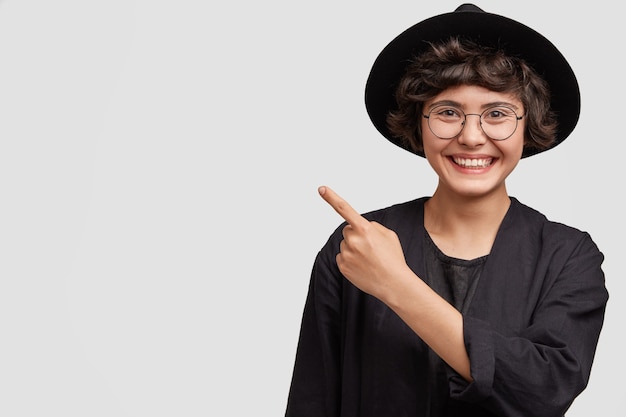 Young woman wearing all black clothes and round eyeglasses