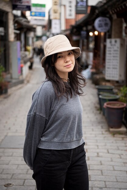 Young woman wearing a bucket hat in the city