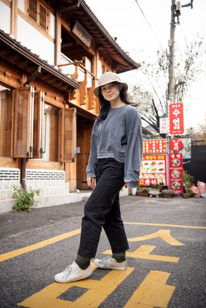 Young woman wearing a bucket hat in the city