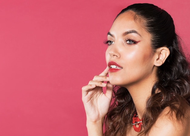 Free photo young woman wearing colorful make-up with copy-space