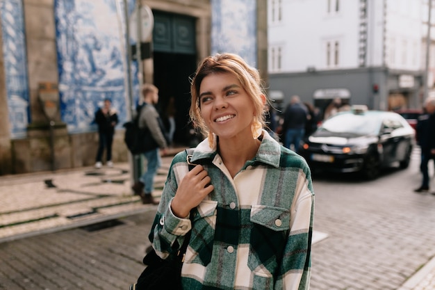 Young woman wearing denim shirt walking on the street city