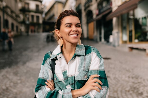 Young woman wearing denim shirt walking on the street city