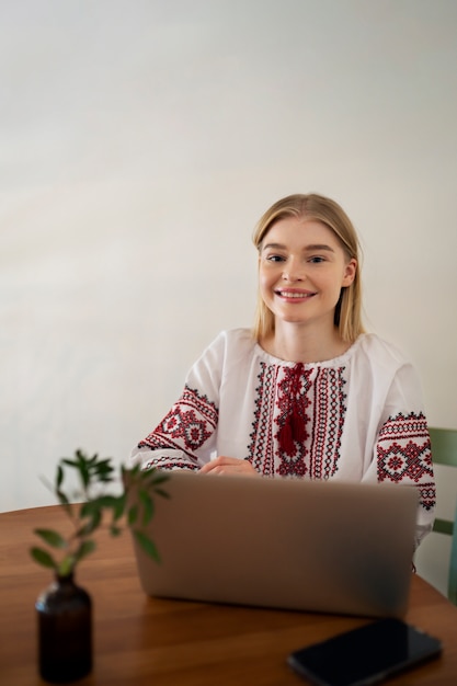 Young woman wearing embroidered shirt