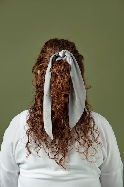 Free photo young woman wearing a handkerchief as a hair accessory