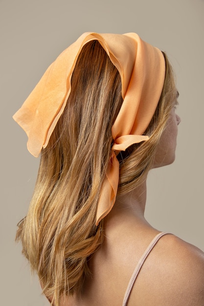 Free photo young woman wearing a handkerchief as a hair accessory