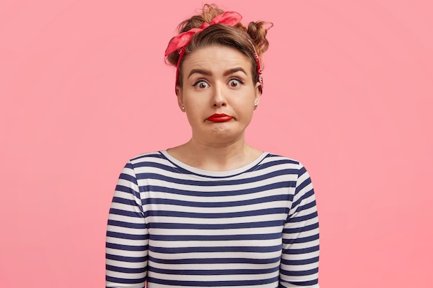 Young woman wearing headband and striped blouse