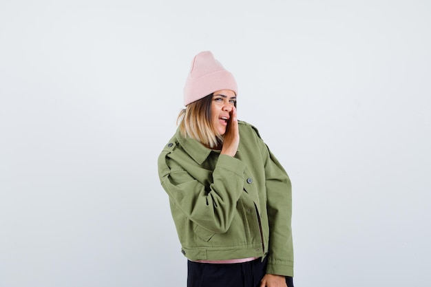 Free Photo young woman wearing a jacket and a pink hat