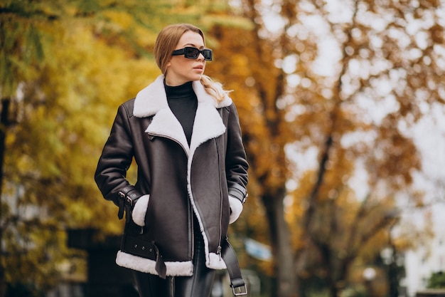 Free Photo young woman wearing jacket walking outside