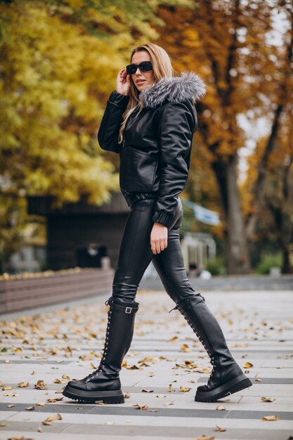 Young woman wearing jacket walking outside