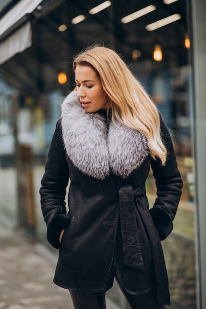 Free photo young woman wearing jacket walking outside