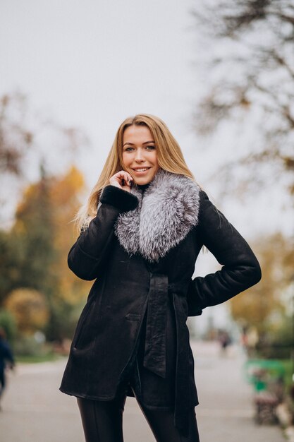 Young woman wearing jacket walking outside