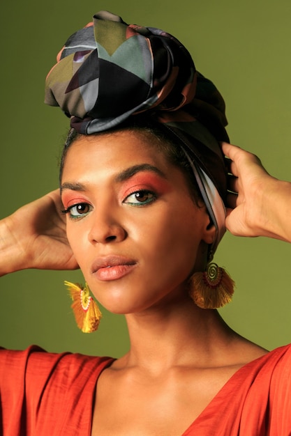 Young woman wearing orange dress with turban and ethnic jewelry