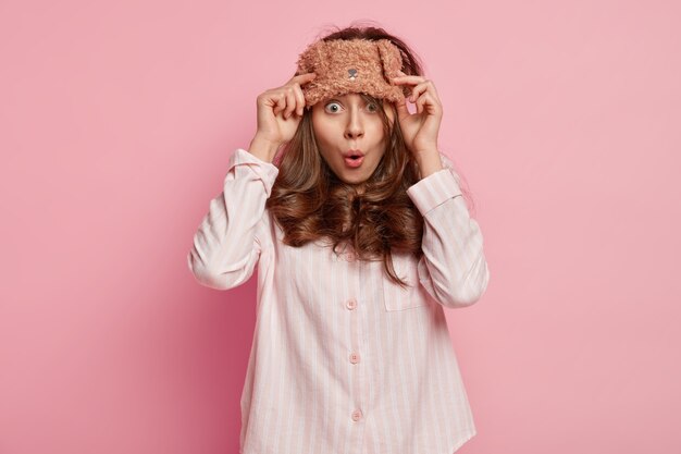 Young woman wearing pajamas and sleep mask