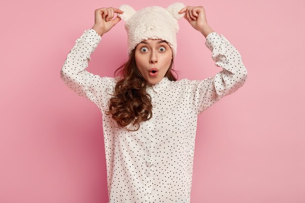 Young woman wearing shirt and funny hat