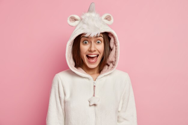 Young woman wearing unicorn pajamas