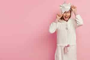 Free photo young woman wearing unicorn pajamas