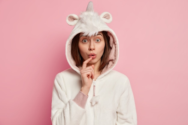 Young woman wearing unicorn pajamas