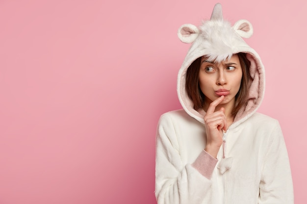 Young woman wearing unicorn pajamas